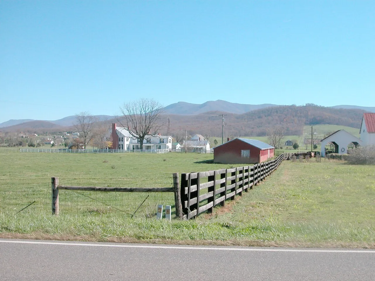 Farm country in the Shenandoah Valley, Virginia — fields, fences and farm buildings with the Blue Ridge beyond